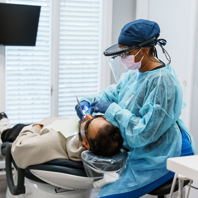 dentist performing a procedure on patient's teeth