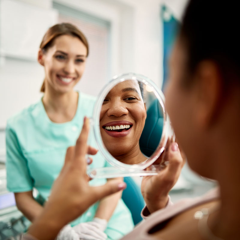 patient checking smile in mirror